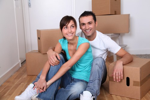 Professional movers carrying office furniture in Soho